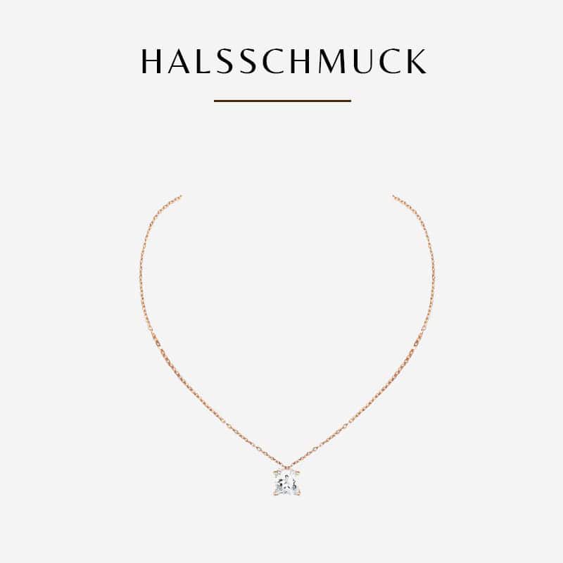 Eine zarte goldene Halskette mit einem einzelnen Anhänger aus klarem Edelstein steht zentriert auf weißem Hintergrund. Über der Halskette steht das Wort „HALSSCHMUCK“ in schwarzer Schrift mit einer horizontalen Linie darunter, was Diavons exquisite Handwerkskunst subtil hervorhebt.