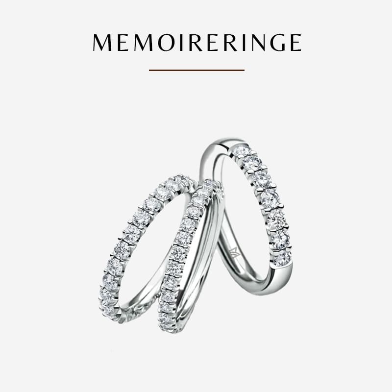Drei elegante, mit Diamanten verzierte Silberringe von Meister sind auf einem weißen Hintergrund zu sehen. Die Ringe sind stehend und leicht überlappend angeordnet. Über den Ringen steht das Wort „MEMOEIRINGE“.