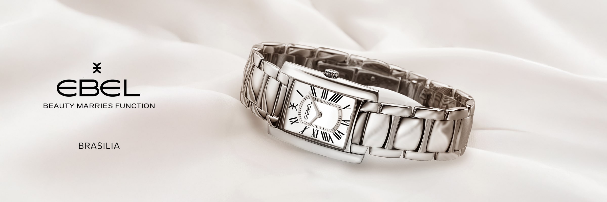 Eine silberne, rechteckige Ebel Brasilia-Armbanduhr mit Metallband und römischen Ziffern auf dem Zifferblatt ruht auf einem weichen, weißen Stoff. Auf der linken Seite sind das EBEL-Logo sowie die Schriftzüge "Beauty Marries Function" und "BRASILIA" zu sehen.