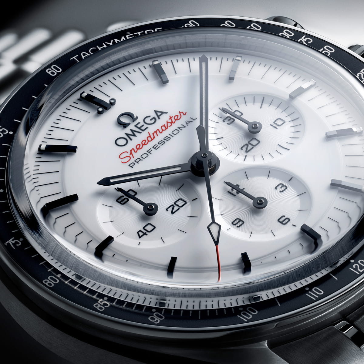 Nahaufnahme des Zifferblatts einer OMEGA Moonwatch Speedmaster Professional mit weißem Zifferblatt, schwarzen Indexen, drei Hilfszifferblättern und dem roten Schriftzug Speedmaster". Die Tachymeterskala sticht auf der ikonischen schwarzen Lünette hervor.